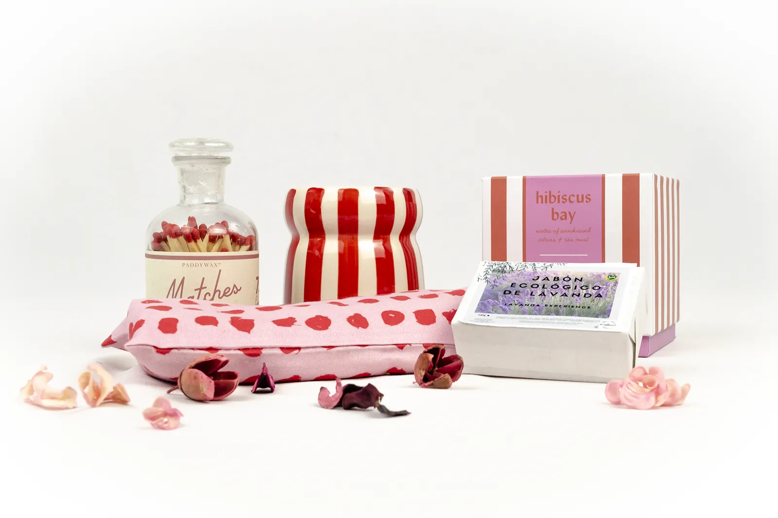 Caja de regalo «Aromas de La Provenza» con vela Paddywax Hibiscus Bay, jabón ecológico de lavanda, botella de cerillas y almohada relajante rosa con corazones rojos.