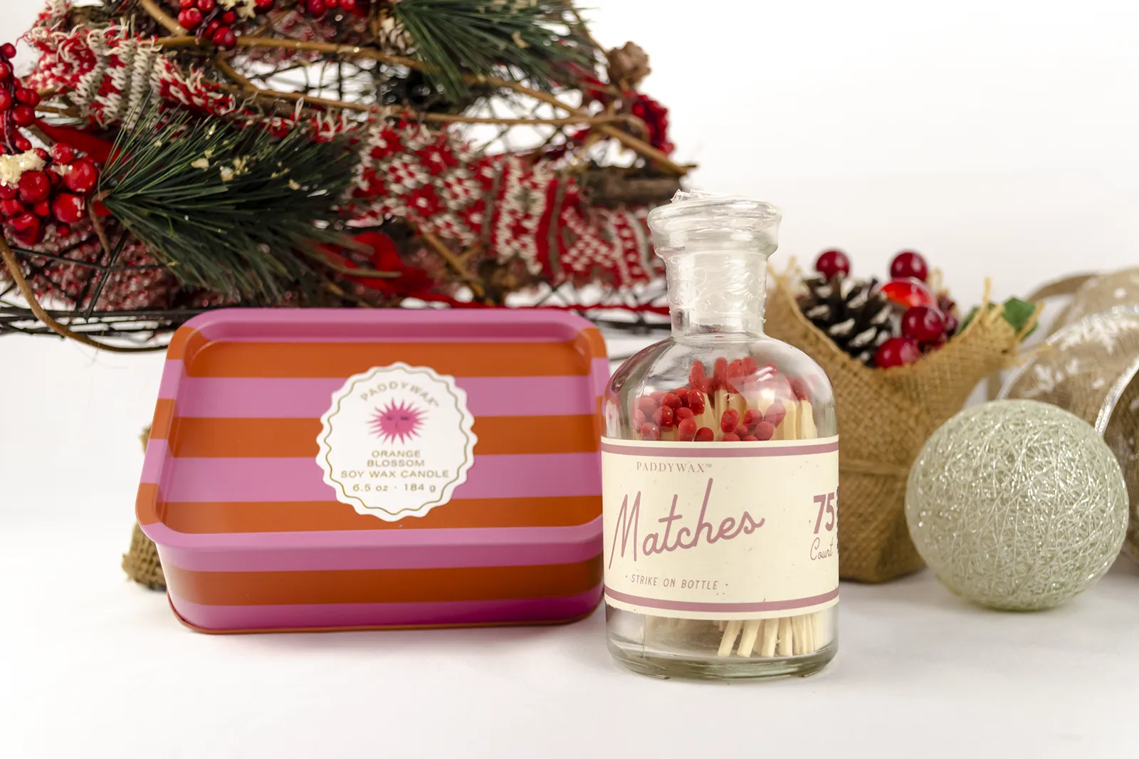 Caja Musuka “Regalo de Navidad 12" que contiene: Una vela en lata Paddywax “Orange Blossom”, y una botella con cerillas “Paddywax”.